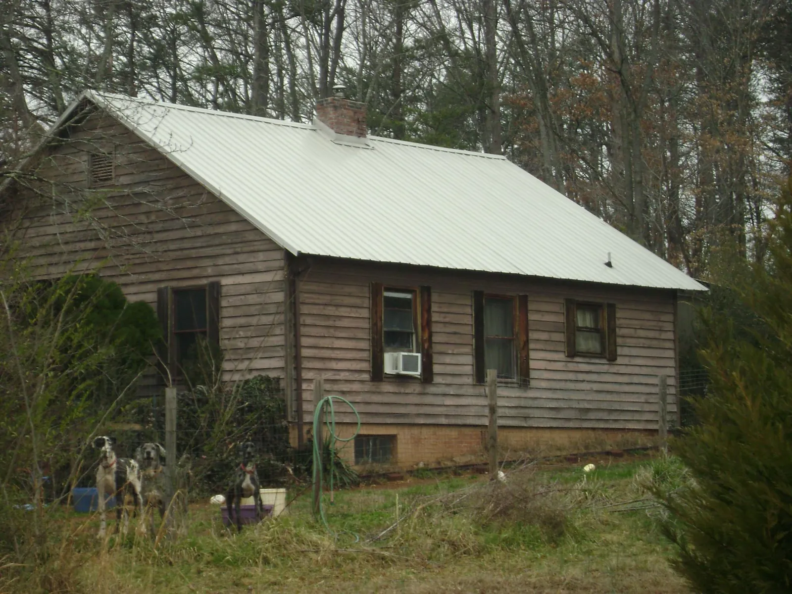 White metal roof on an old wood sided farmhouse, from a Metal Roof Installation job in Fort Ann